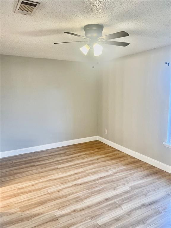 unfurnished room with ceiling fan, light hardwood / wood-style floors, and a textured ceiling