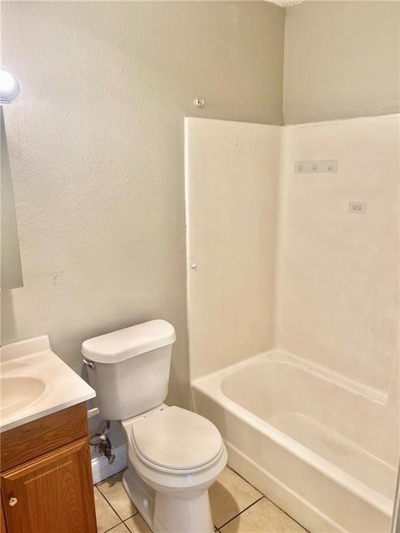 full bathroom with washtub / shower combination, tile patterned floors, toilet, and vanity