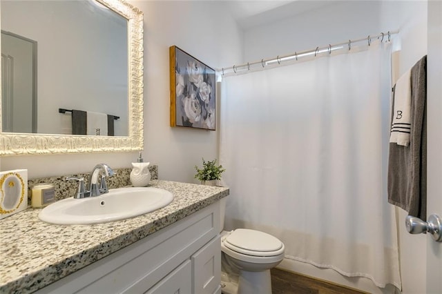 full bathroom with vanity, hardwood / wood-style floors, shower / bathtub combination with curtain, and toilet