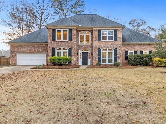 view of front of house with a garage and a front lawn