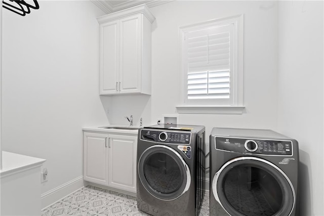 laundry area with sink, washing machine and dryer, cabinets, and light tile patterned flooring