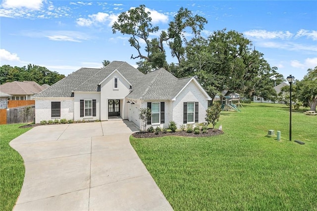 view of front of home featuring a playground and a front lawn