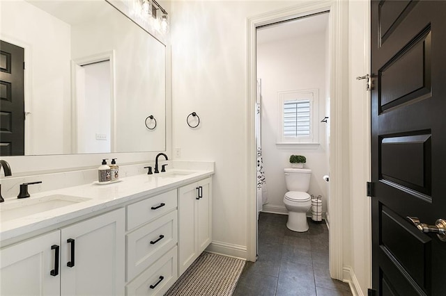 bathroom with vanity, toilet, and tile patterned flooring