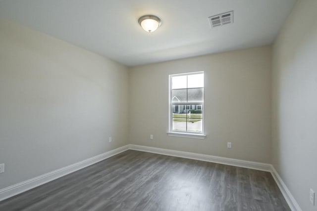 unfurnished room with dark hardwood / wood-style flooring