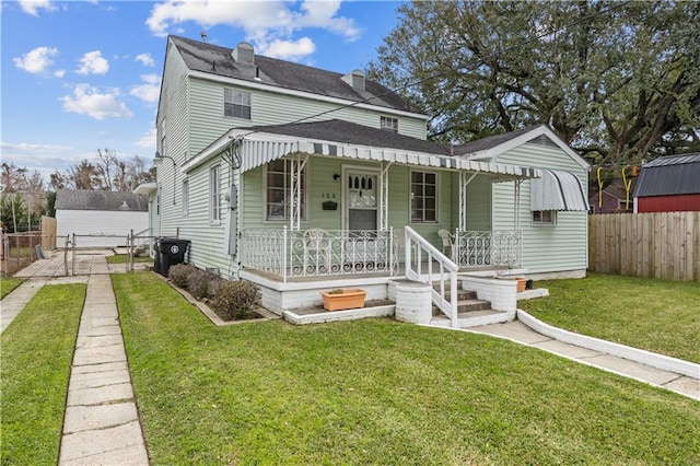 view of front of house with covered porch and a front lawn