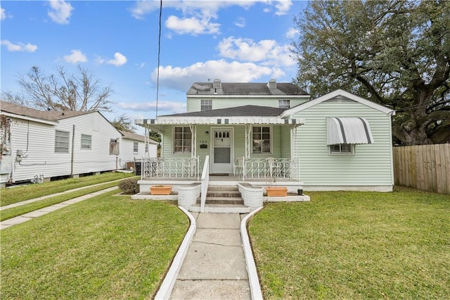 bungalow with a porch and a front yard