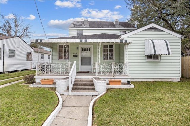 bungalow-style house featuring a front yard and covered porch