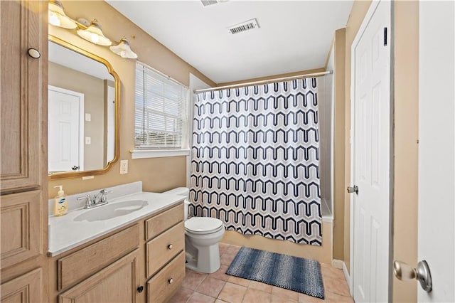 full bathroom featuring vanity, shower / bathtub combination with curtain, tile patterned floors, and toilet