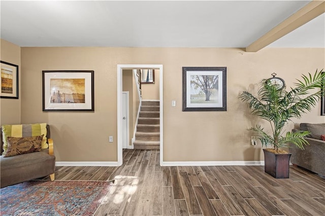 living area featuring beamed ceiling