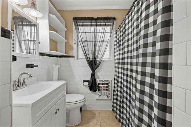 bathroom with tile patterned flooring, vanity, tile walls, and toilet