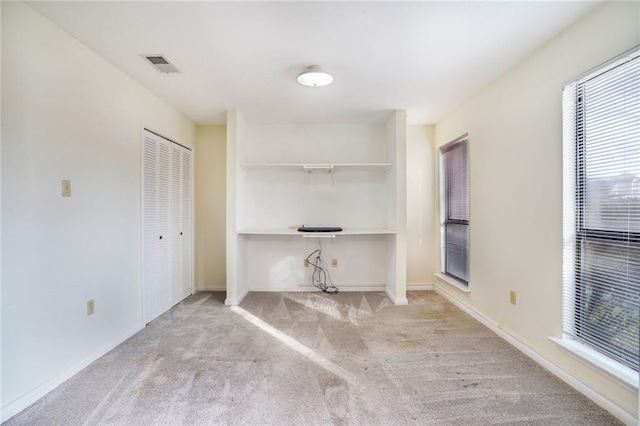 unfurnished office featuring light colored carpet