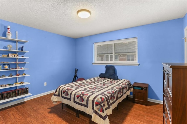 bedroom featuring dark hardwood / wood-style floors and a textured ceiling