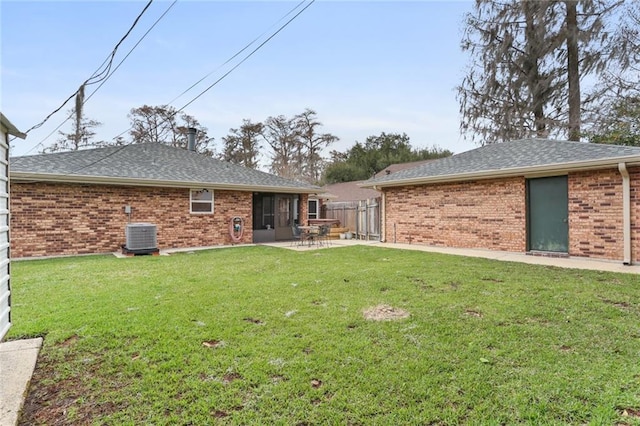 rear view of house featuring a yard, a patio area, and central AC