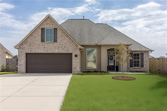 view of front of home with a garage and a front yard