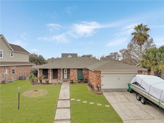 ranch-style house featuring a garage, a front yard, and central air condition unit