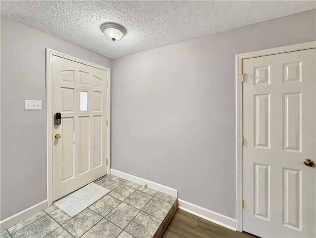 entryway featuring hardwood / wood-style floors and a textured ceiling