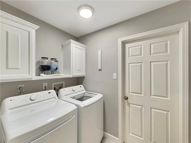 laundry room with cabinets and washer and clothes dryer