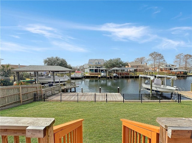 dock area with a lawn and a water view