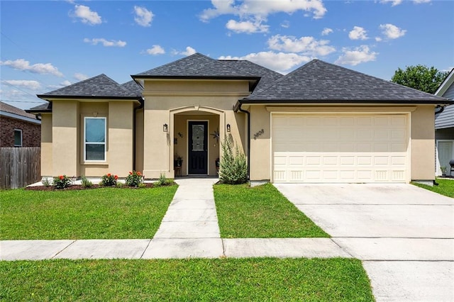 view of front facade with a garage and a front yard