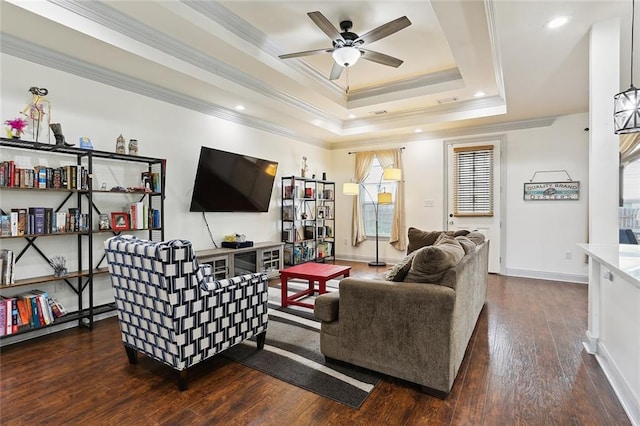 living room featuring crown molding, ceiling fan, dark hardwood / wood-style floors, and a raised ceiling