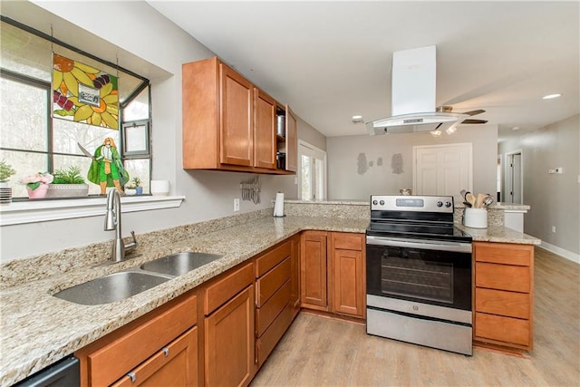 kitchen featuring sink, island range hood, electric range, kitchen peninsula, and light stone countertops