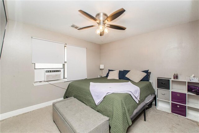 bedroom with cooling unit, light colored carpet, and ceiling fan