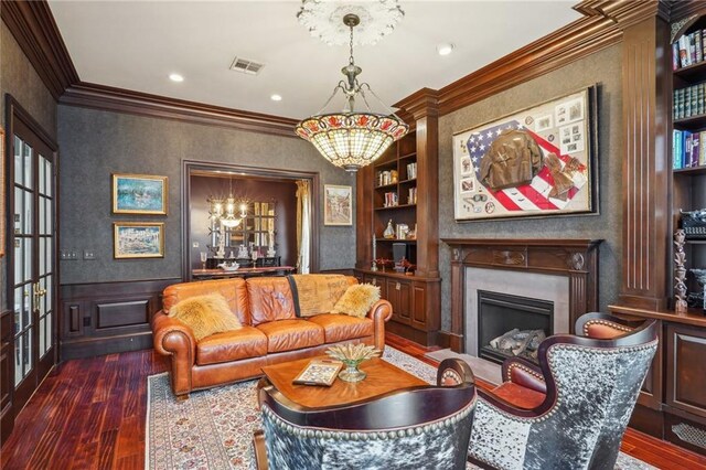 180 E Oakridge Park, Metairie, LA 70005 - sitting room featuring a notable chandelier, ornamental molding, built in features, and dark hardwood / wood-style floors