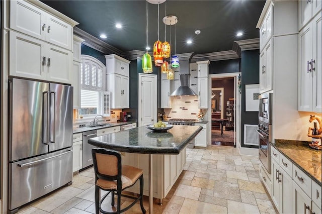 180 E Oakridge Park, Metairie, LA 70005 - kitchen with pendant lighting, a breakfast bar, stainless steel appliances, a center island, and dark stone counters