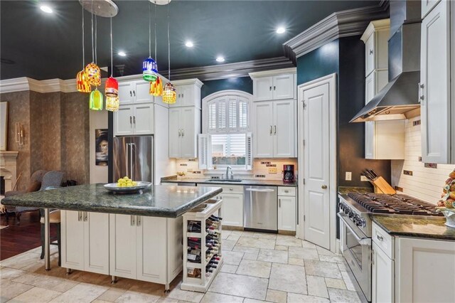 180 E Oakridge Park, Metairie, LA 70005 - kitchen with pendant lighting, white cabinetry, high end appliances, a center island, and wall chimney range hood