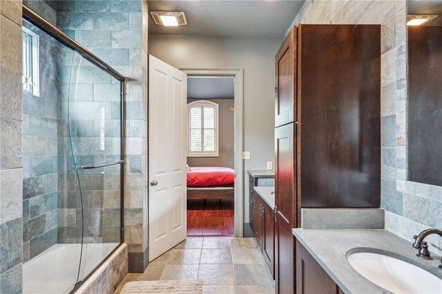 180 E Oakridge Park, Metairie, LA 70005 - bathroom with vanity and combined bath / shower with glass door