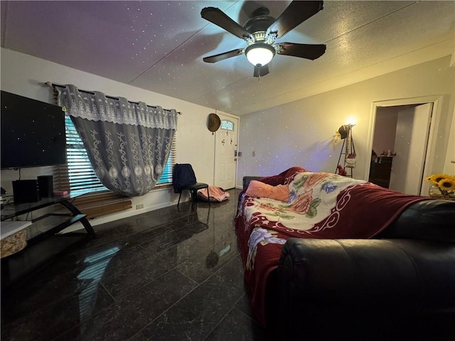 bedroom with granite finish floor, vaulted ceiling, and ceiling fan