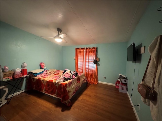 bedroom with ceiling fan, baseboards, and wood finished floors