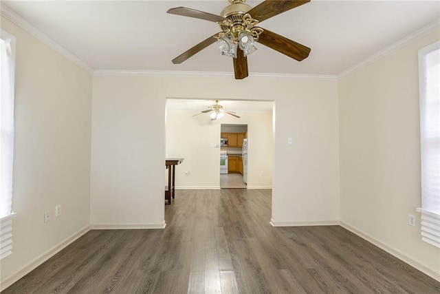 empty room with dark wood-type flooring and ornamental molding