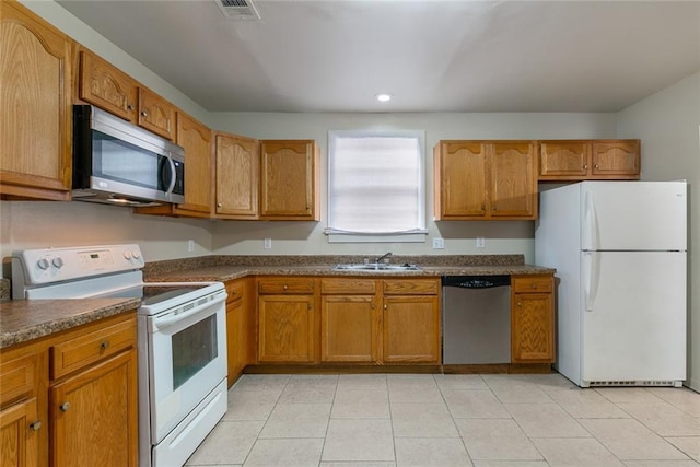 kitchen with stainless steel appliances, sink, and light tile patterned floors