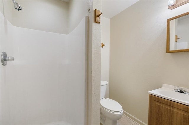 bathroom with vanity, walk in shower, tile patterned floors, and toilet