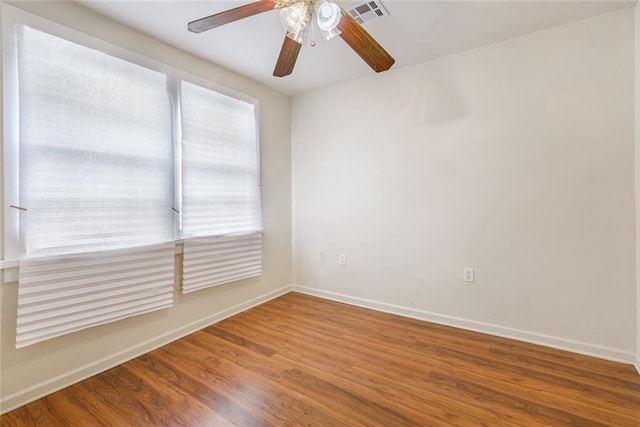 unfurnished room with ceiling fan and hardwood / wood-style floors