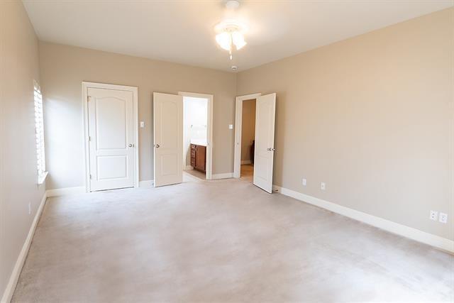 unfurnished bedroom with ensuite bath and baseboards