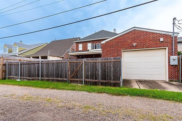 exterior space with an attached garage and fence