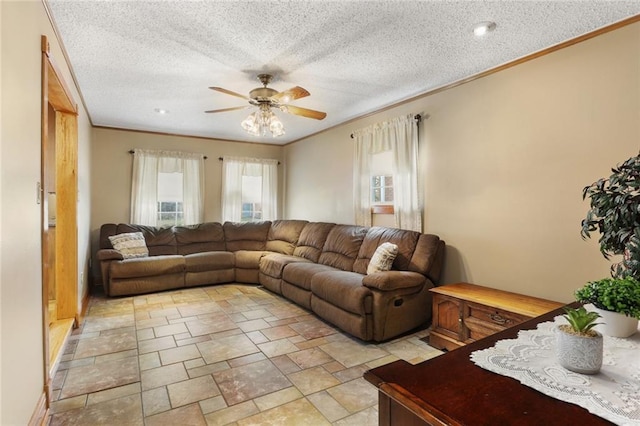 living room featuring ornamental molding, ceiling fan, and a textured ceiling