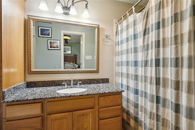 ensuite bathroom with a shower with shower curtain, vanity, and ensuite bath