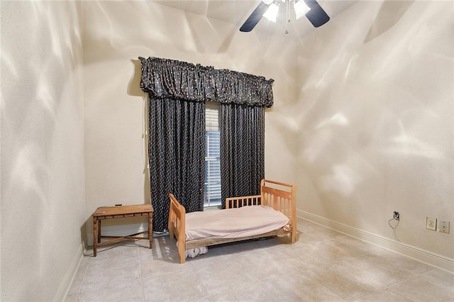 bedroom with a ceiling fan, baseboards, and tile patterned floors