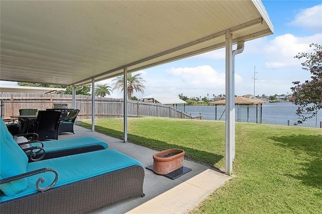 view of patio / terrace featuring a water view and a fenced backyard