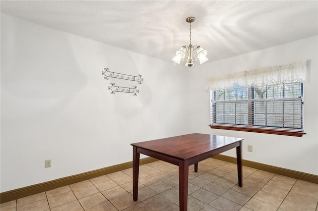 unfurnished dining area with light tile patterned floors and a notable chandelier