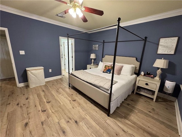 bedroom with ceiling fan, ornamental molding, and light hardwood / wood-style floors