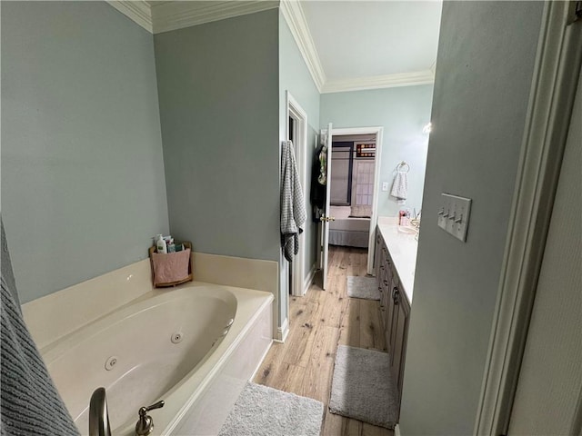 bathroom featuring vanity, a bathtub, wood-type flooring, and ornamental molding