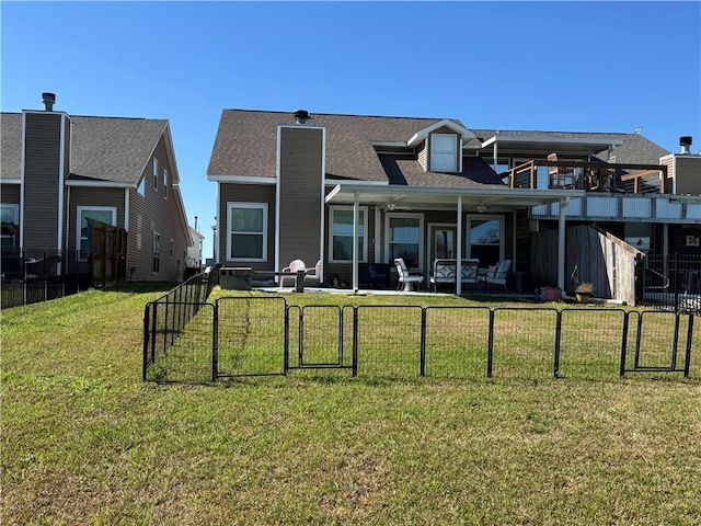 back of house featuring a yard