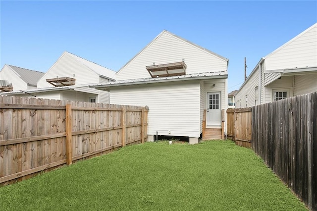 rear view of house featuring a yard