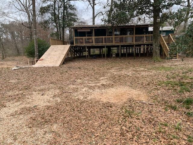 rear view of property featuring a deck