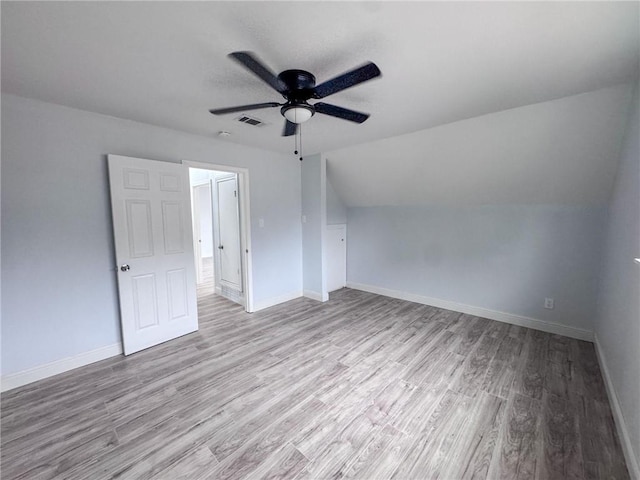 bonus room featuring light wood-type flooring and baseboards