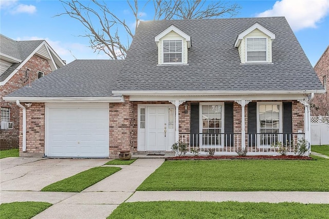 view of front of house with cooling unit, a porch, a garage, and a front yard